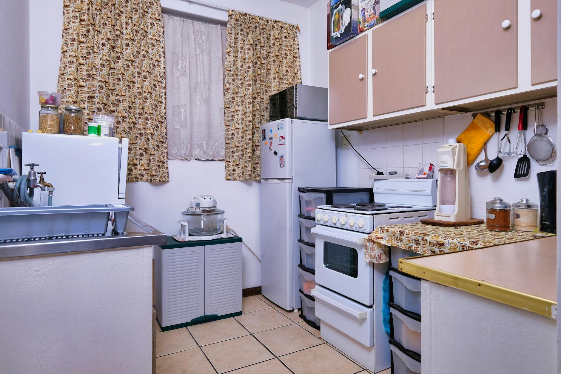 A compact kitchen featuring modern appliances and cozy design elements, perfect for small homes.