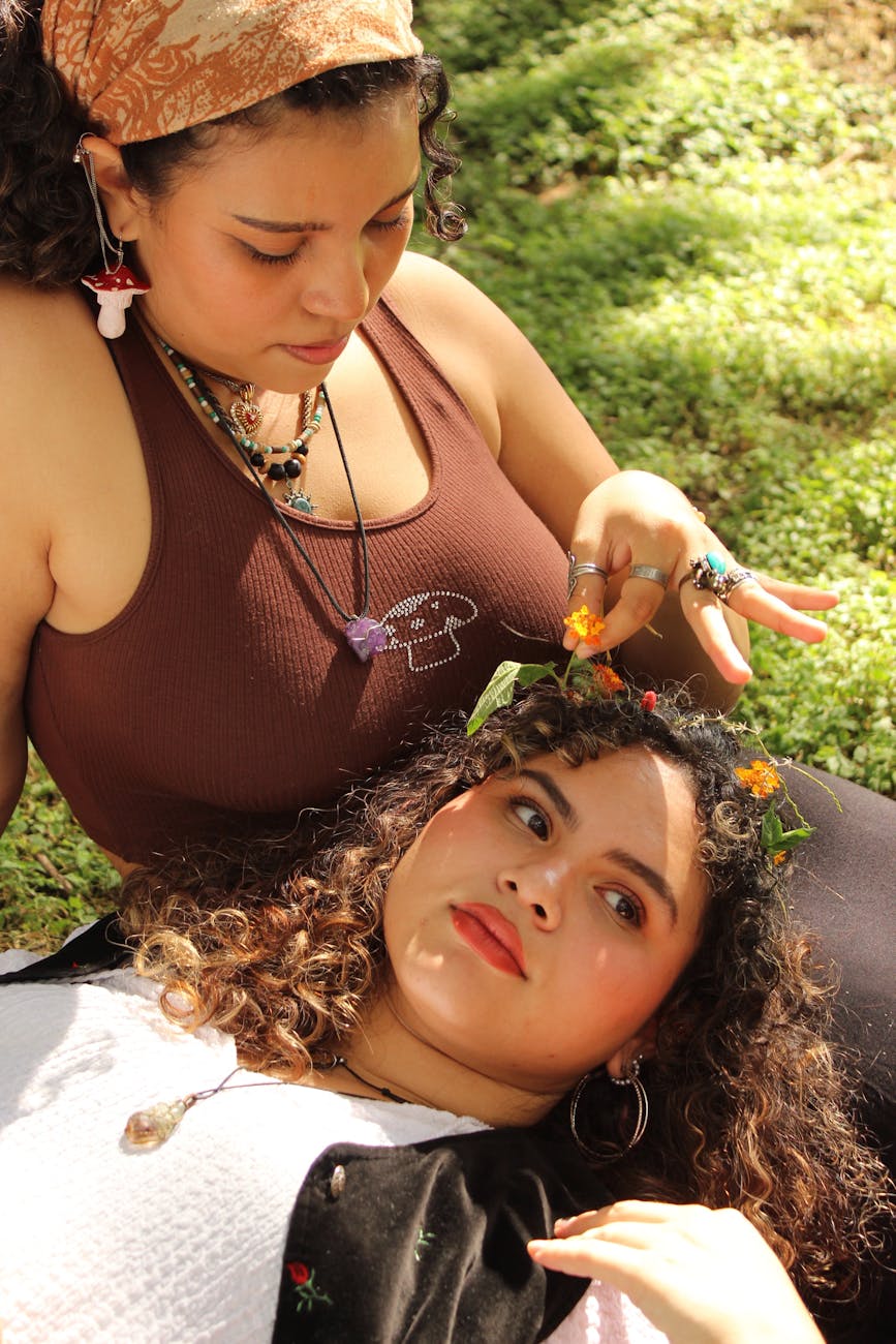 Two women relaxing in a sunny garden in El Salvador, enjoying leisure and nature.